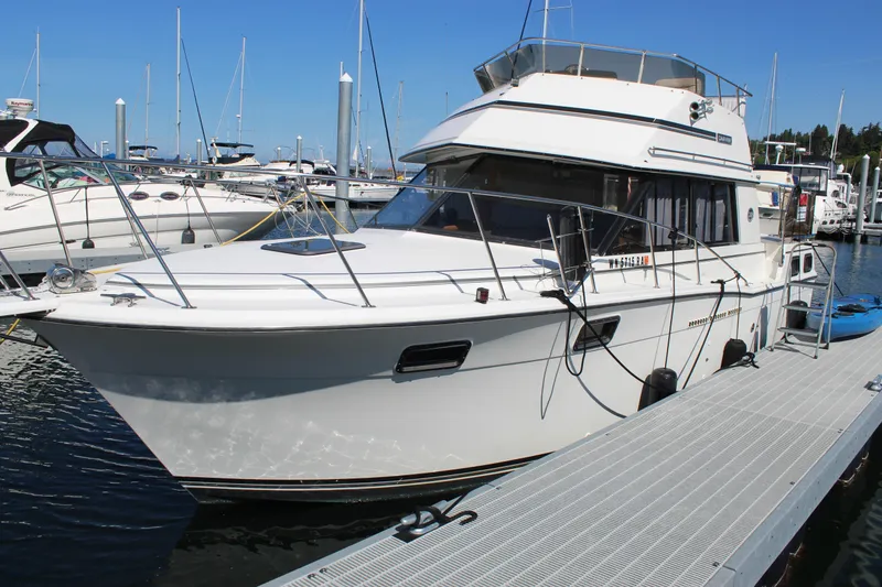 Slide: The Image of 1990 Carver 3207 Aft Cabin Motor Yacht docked at marina under clear blue sky. - 2