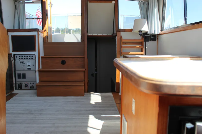 Slide: The Image of Interior of 1990 Carver 3207 Aft Cabin Motor Yacht with wooden stairs and control panel. - 24