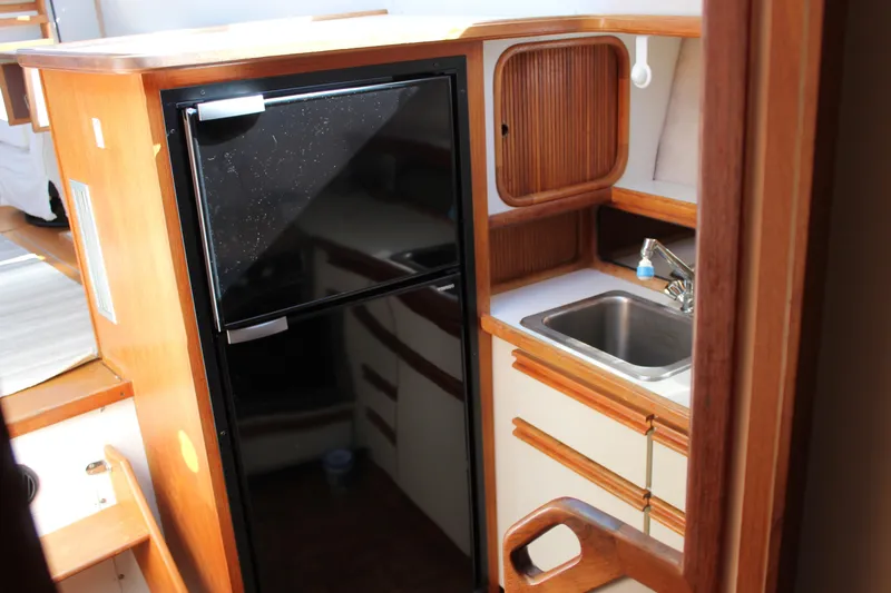 Slide: The Image of Interior of 1990 Carver 3207 Aft Cabin Motor Yacht kitchen with sink and fridge. - 25