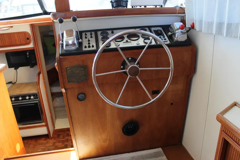 Slide: The Image of Steering wheel and controls of a 1990 Carver 3207 Aft Cabin Motor Yacht. - 35