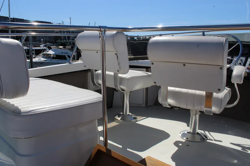 Slide: The Image of 1990 Carver 3207 Aft Cabin Motor Yacht interior with white seating and helm. - 37