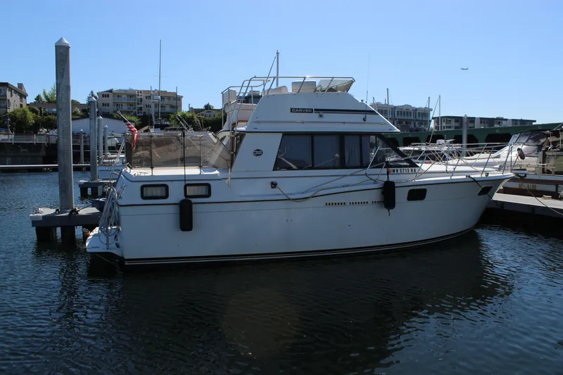 Slide: The Image of 1990 Carver 3207 Aft Cabin Motor Yacht docked at marina, sunny day. - 4
