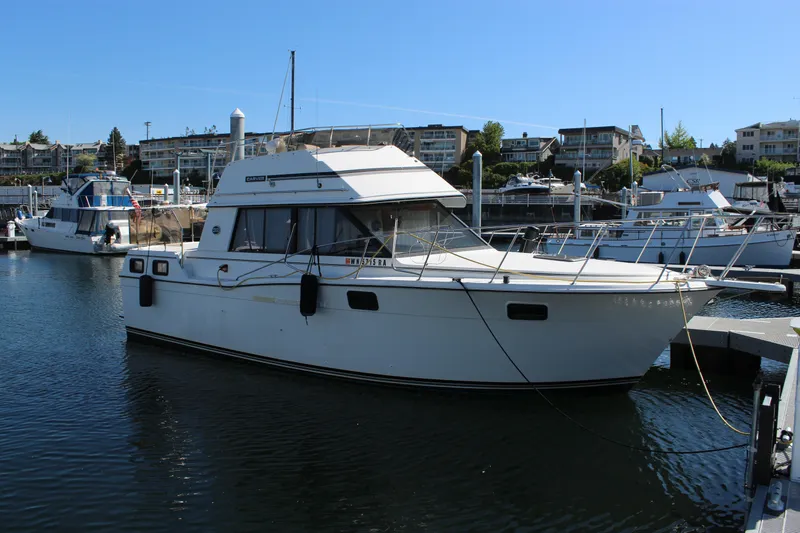 Slide: The Image of 1990 Carver 3207 Aft Cabin Motor Yacht docked at a marina. - 5