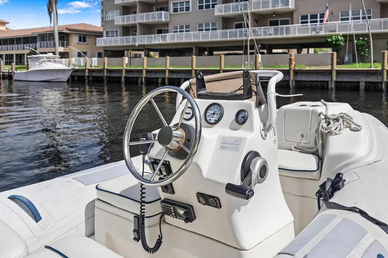 Slide: The Image of Cockpit of 2008 Sea Ray 44 Sundancer boat docked near waterfront buildings. - 21
