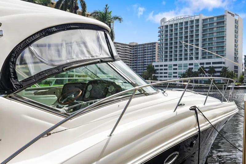 Slide: The Image of 2008 Sea Ray 44 Sundancer yacht docked near modern waterfront buildings. - 3