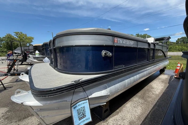 The Image of 2022 Manitou Aurora LE pontoon boat displayed outdoors for sale. - 0