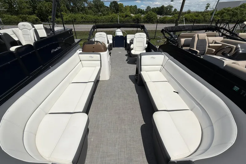 Slide: The Image of 2022 Manitou Aurora LE pontoon boat with spacious seating and modern design. - 10