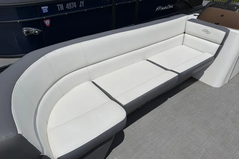 Slide: The Image of 2022 Manitou Aurora LE boat with white cushioned seating. - 11