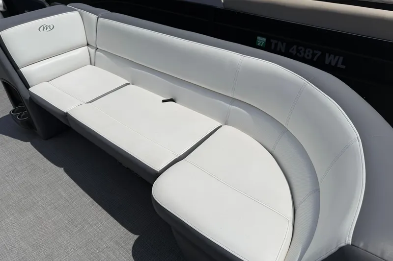 Slide: The Image of 2022 Manitou Aurora LE boat interior with white cushioned seating. - 12