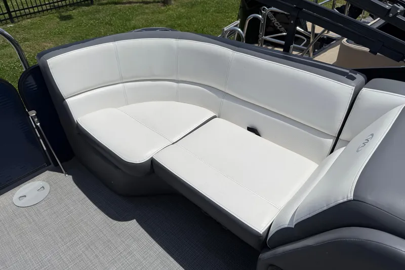 Slide: The Image of 2022 Manitou Aurora LE boat with white cushioned seating on deck. - 6