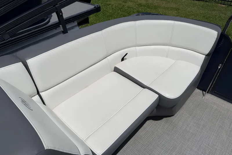 Slide: The Image of 2022 Manitou Aurora LE boat with white cushioned seating on deck. - 7