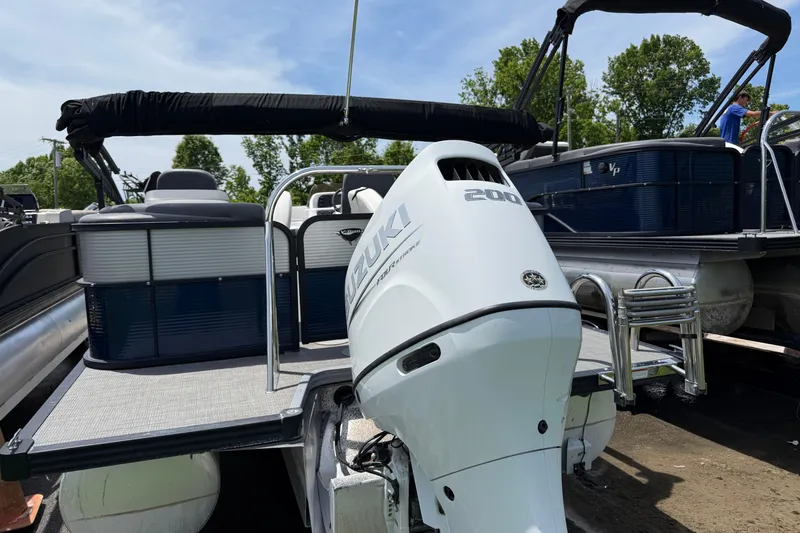 Slide: The Image of 2022 Manitou Aurora LE pontoon boat with Suzuki 200 outboard motor, docked outdoors. - 8