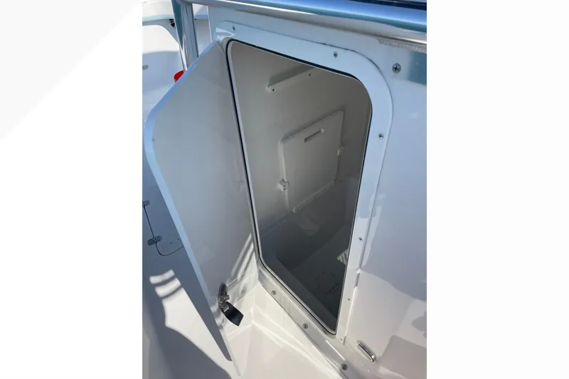 Slide: The Image of Open storage compartment on 2023 Bluewater Sportfishing 23t boat. - 14