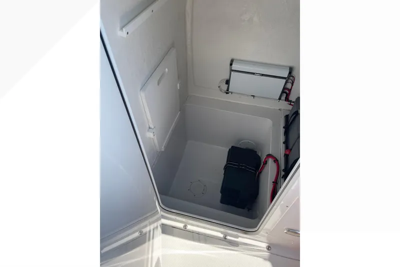 Slide: The Image of 2023 Bluewater Sportfishing 23t boat storage compartment with electrical components. - 15