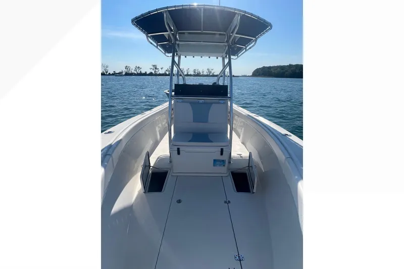 Slide: The Image of 2023 Bluewater Sportfishing 23t boat on water, featuring center console and T-top. - 17