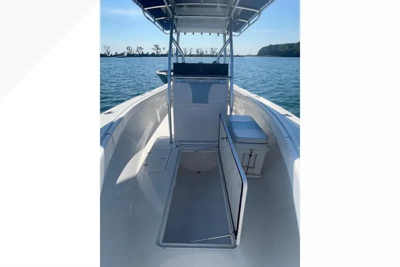 Slide: The Image of 2023 Bluewater Sportfishing 23t boat interior with open hatch, on calm water. - 18