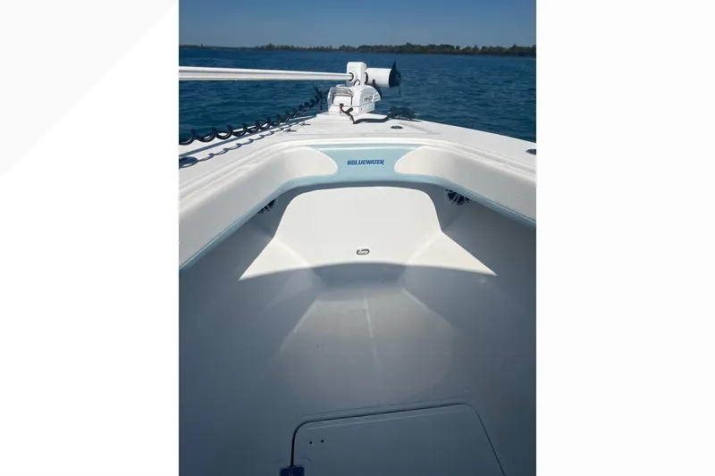 Slide: The Image of 2023 Bluewater Sportfishing 23t boat on calm blue water, showcasing sleek design. - 19