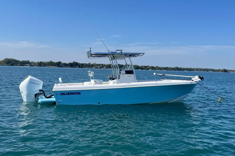 Slide: The Image of 2023 Bluewater Sportfishing 23t boat on calm water with Mercury engine. - 2