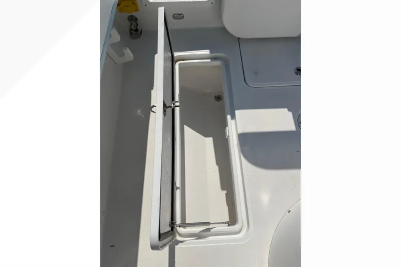 Slide: The Image of Open storage compartment on 2023 Bluewater Sportfishing 23t boat deck. - 20