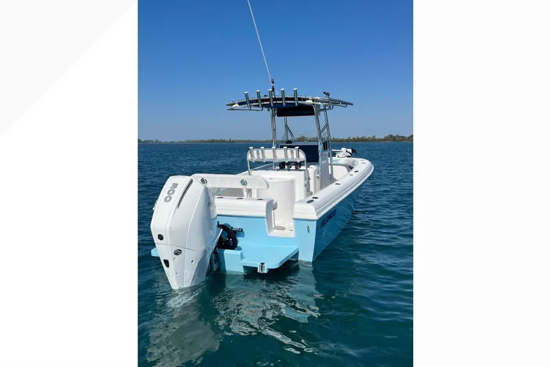 Slide: The Image of 2023 Bluewater Sportfishing 23t boat on calm blue water, rear view. - 5