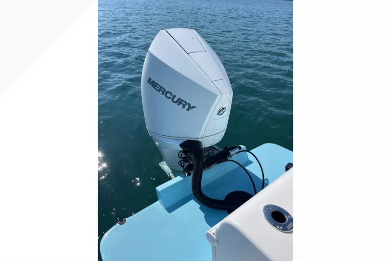 Slide: The Image of 2023 Bluewater Sportfishing 23t boat with Mercury outboard engine on calm water. - 6