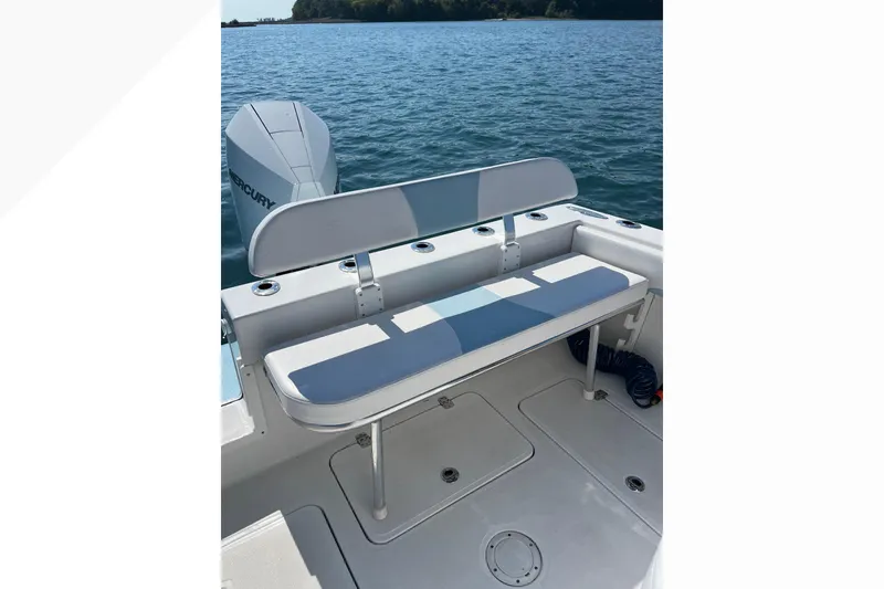 Slide: The Image of 2023 Bluewater Sportfishing 23t boat with seating and Mercury engine on calm water. - 7