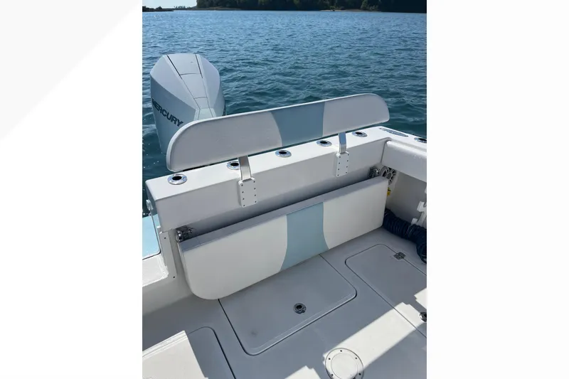 Slide: The Image of 2023 Bluewater Sportfishing 23t boat interior with Mercury engine on a calm lake. - 8