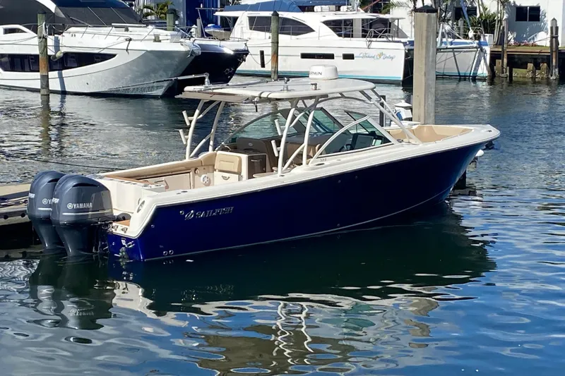 Slide: The Image of 2018 Sailfish 325 DC boat docked with twin Yamaha engines. - 35