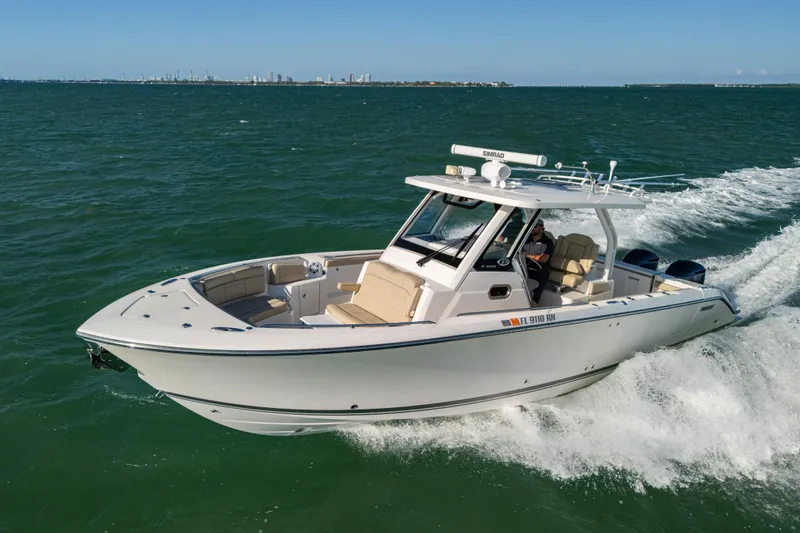The Image of 2018 Pursuit S 328 Sport boat cruising on open water, showcasing sleek design and powerful performance. - 1
