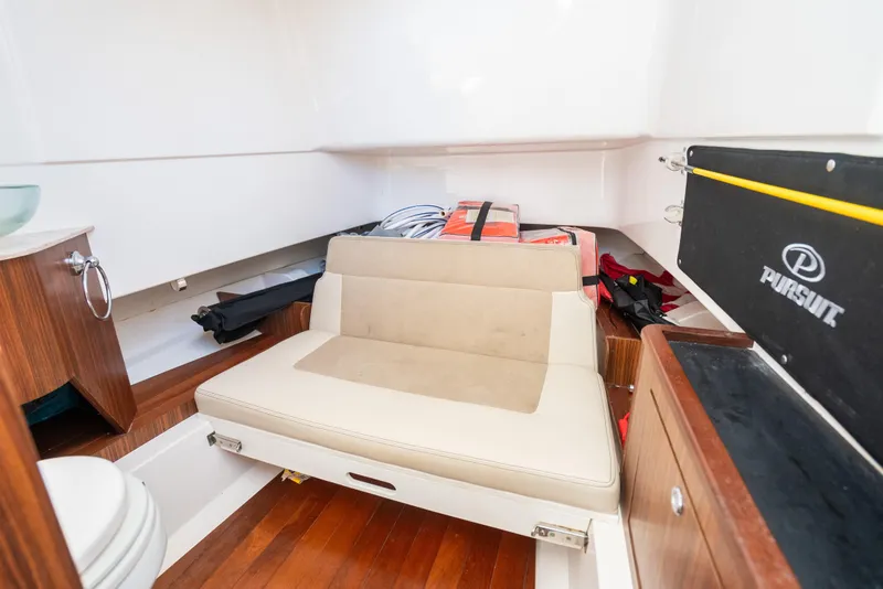 Slide: The Image of 2018 Pursuit S 328 Sport cabin interior with seating and storage. - 16