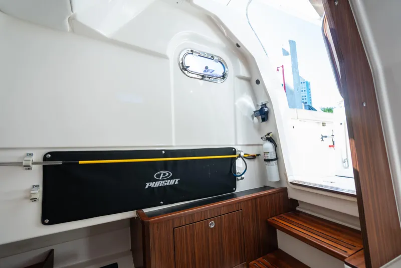 Slide: The Image of Interior of 2018 Pursuit S 328 Sport boat with wooden steps and safety equipment. - 20