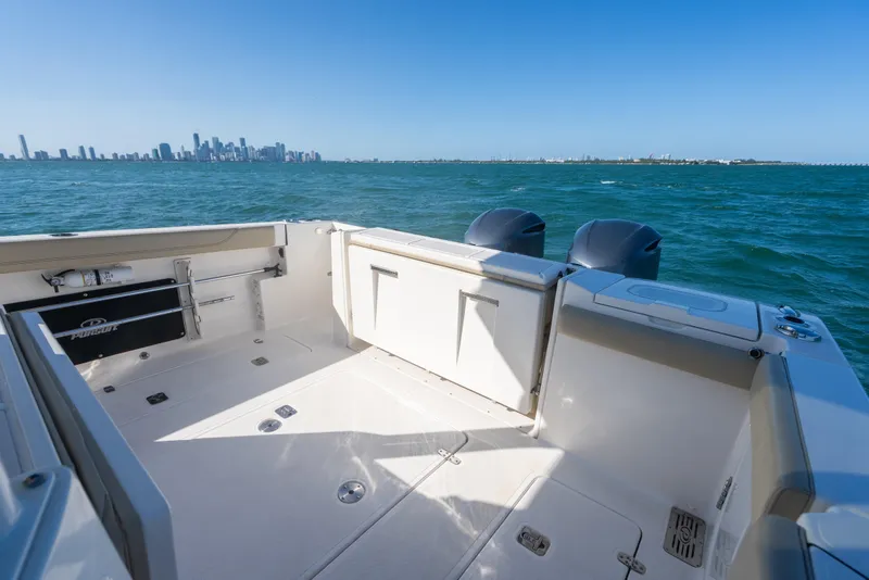 Slide: The Image of 2018 Pursuit S 328 Sport boat deck with city skyline in background. - 21