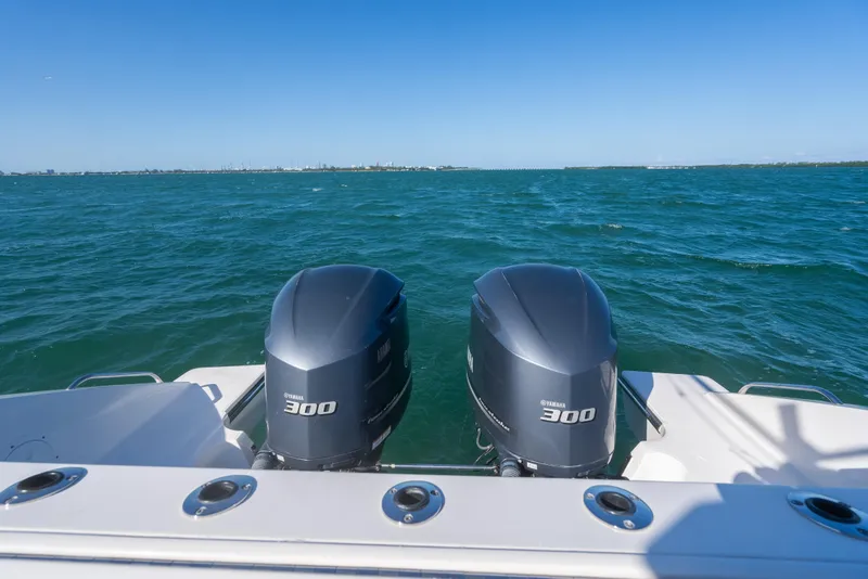 Slide: The Image of 2018 Pursuit S 328 Sport boat with twin Yamaha 300 engines on open water. - 22