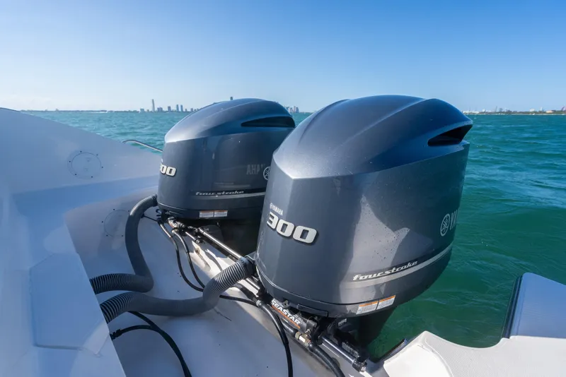 Slide: The Image of Twin Yamaha 300 outboard engines on a 2018 Pursuit S 328 Sport boat in open water. - 24