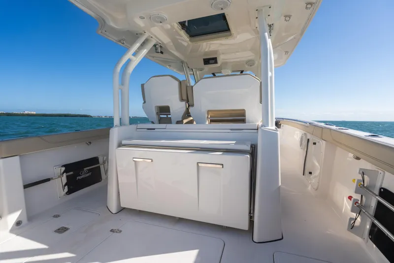 Slide: The Image of 2018 Pursuit S 328 Sport boat interior with seating and ocean view. - 25