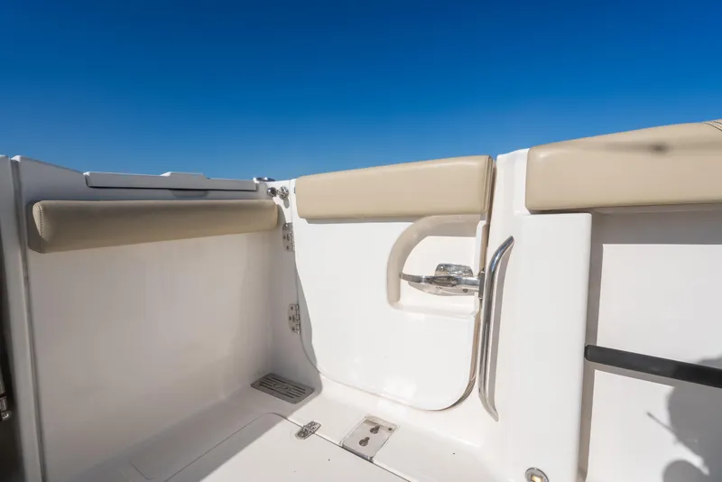 Slide: The Image of 2018 Pursuit S 328 Sport boat interior with beige seating and stainless steel handle. - 29