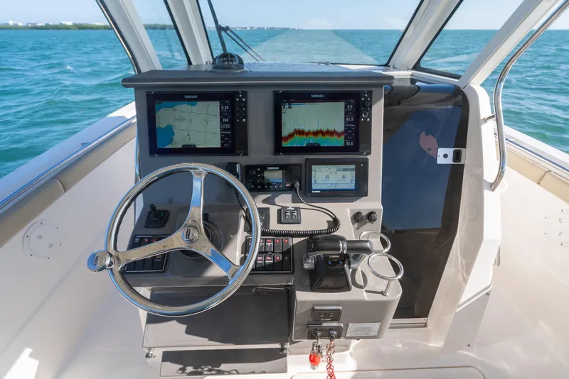 Slide: The Image of Cockpit of 2018 Pursuit S 328 Sport boat with navigation screens and steering wheel. - 35