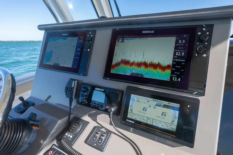 Slide: The Image of Dashboard of 2018 Pursuit S 328 Sport boat with Simrad navigation displays. - 38