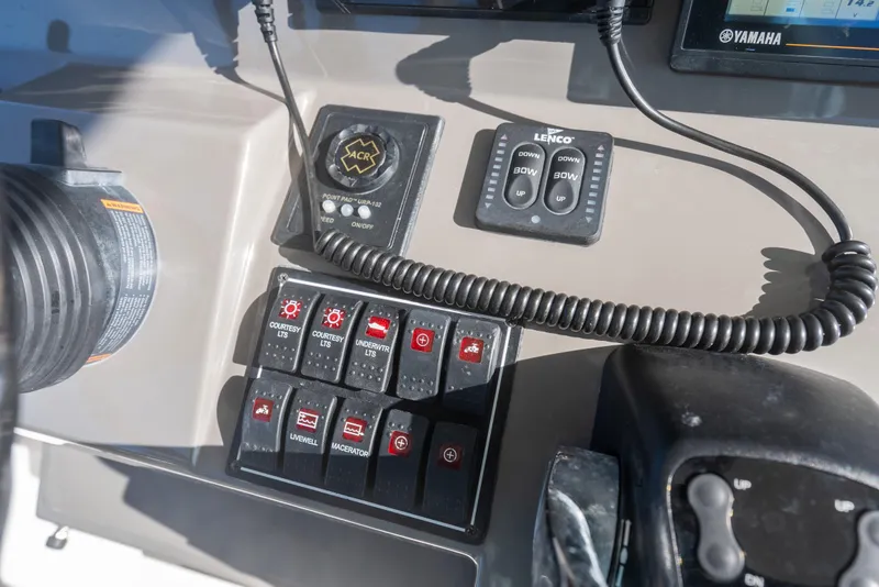 Slide: The Image of Control panel of 2018 Pursuit S 328 Sport boat with switches and controls. - 39