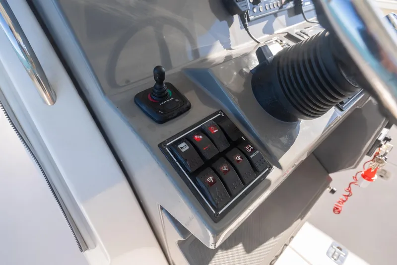 Slide: The Image of Control panel of 2018 Pursuit S 328 Sport boat with joystick and switches. - 40