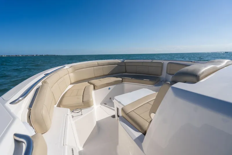 Slide: The Image of 2018 Pursuit S 328 Sport boat with beige seating on open water. - 42