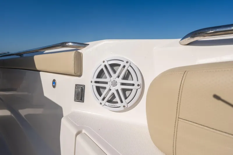 Slide: The Image of 2018 Pursuit S 328 Sport boat interior with JL Audio speaker and beige seating. - 47