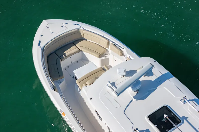 Slide: The Image of 2018 Pursuit S 328 Sport boat with spacious seating on calm green water. - 5