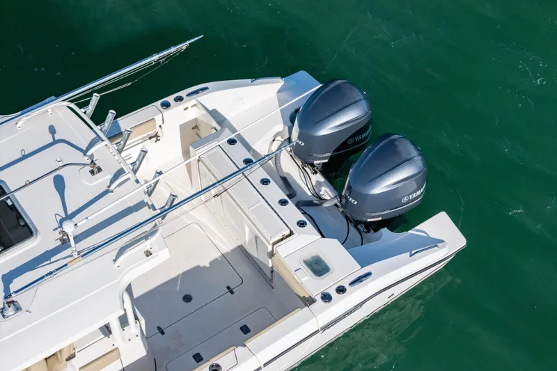 Slide: The Image of 2018 Pursuit S 328 Sport boat with dual Yamaha engines on clear water. - 6
