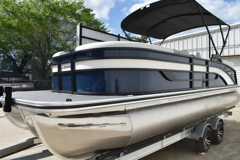Slide: The Image of 2026 Lowe SS 230 WT Special pontoon boat on trailer, featuring sleek design and canopy. - 16