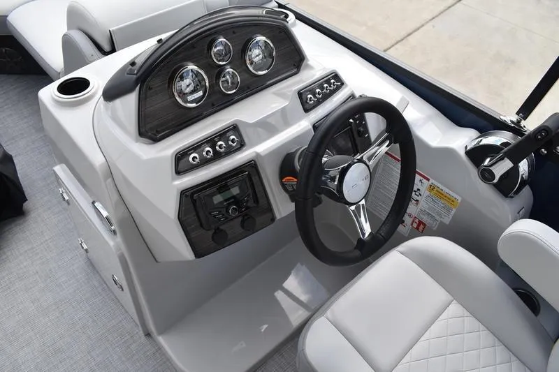 Slide: The Image of 2026 Lowe SS 230 WT Special boat dashboard with steering wheel and control panel. - 32