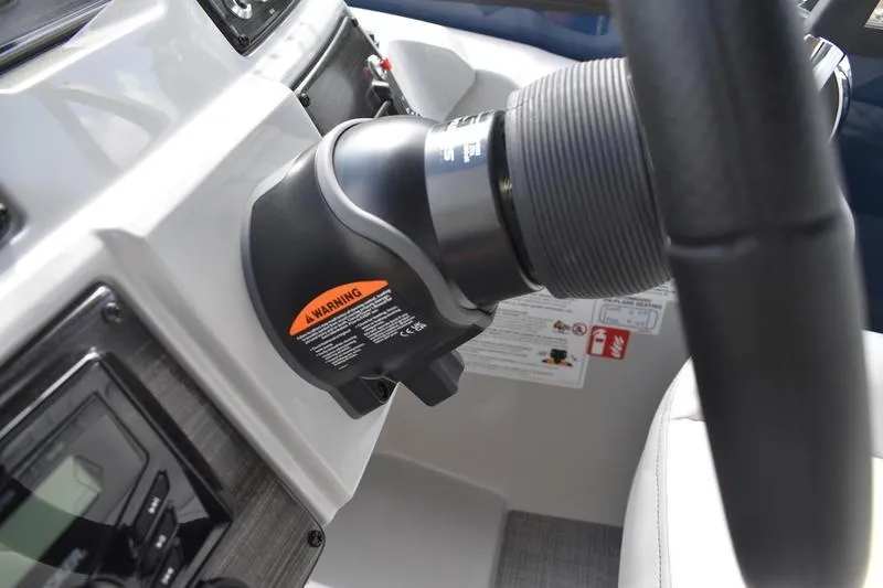 Slide: The Image of Steering console of 2026 Lowe SS 230 WT Special boat, featuring modern controls and warning labels. - 38