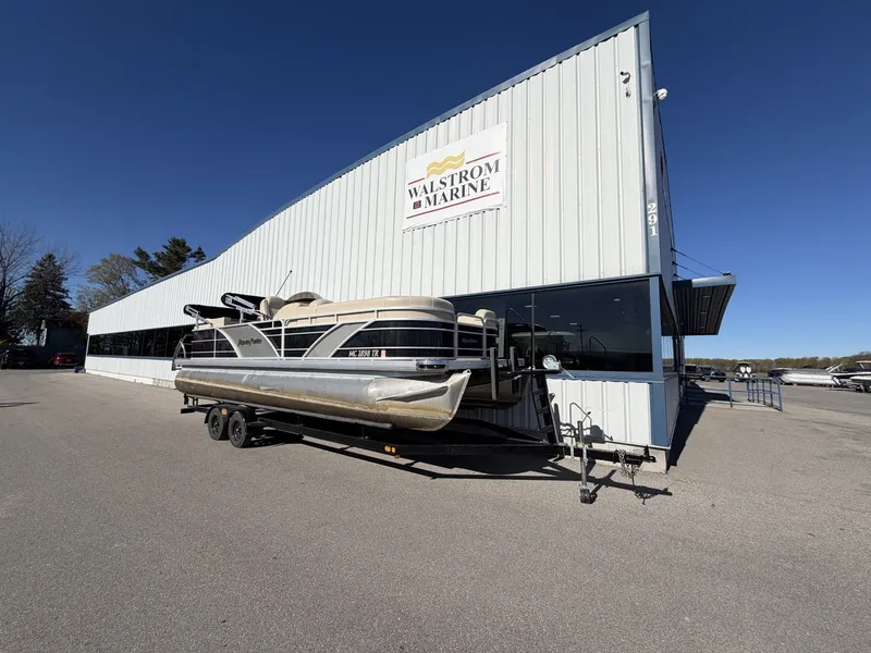 The Image of Godfrey Aqua Patio CB 240 boat outside Walstrom Marine building. - 0