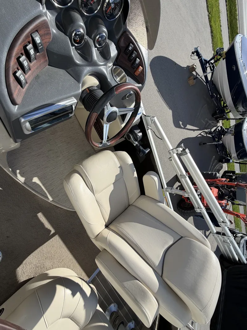 Slide: The Image of Interior of a 2014 Godfrey Aqua Patio CB 240 boat with steering console. - 10