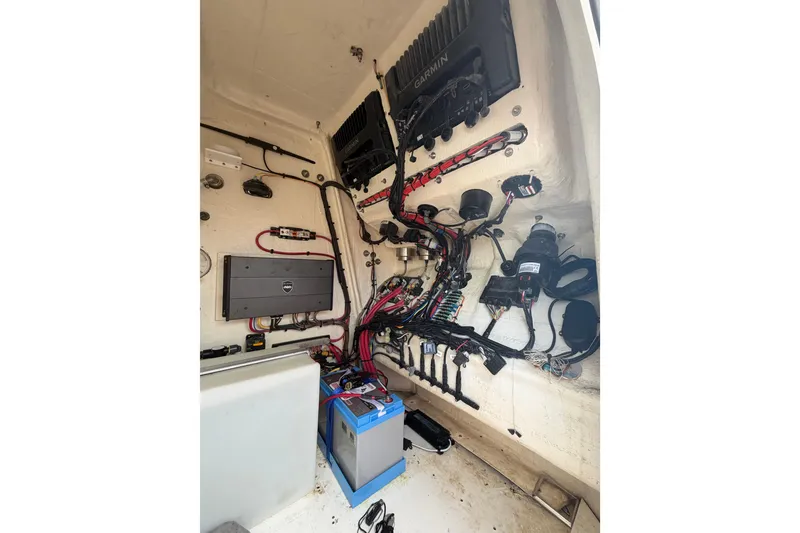 Slide: The Image of Electrical system inside a 2020 Sea Cat 260 boat, featuring wiring and equipment. - 12